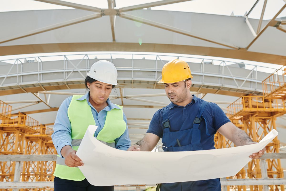 Equipe técnica revisando projeto em obra.